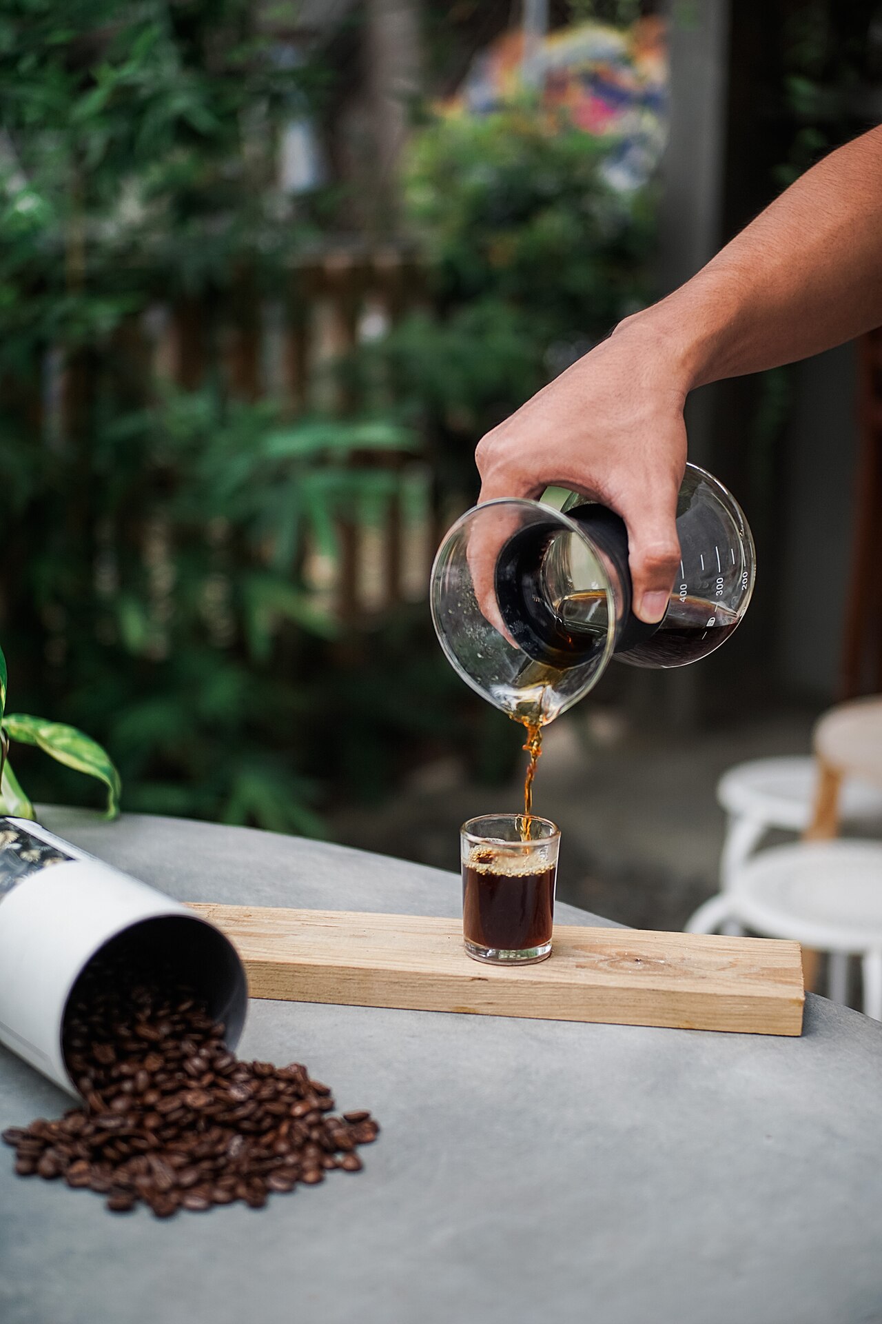 Two glasses, one with dark cold brew and another with lighter iced coffee, both filled with ice.