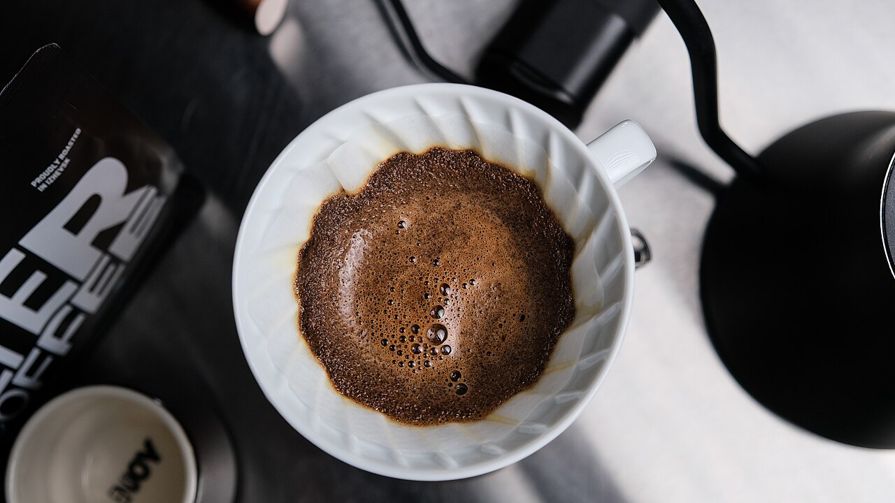 Close-up of coffee blooming in a Hario V60 pour-over dripper on a scale